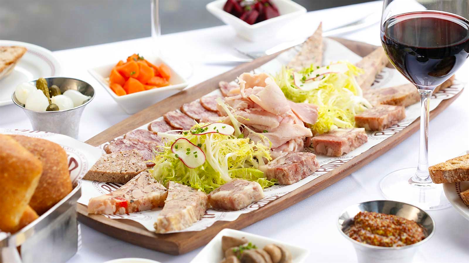 A plate of terrine from Bar Boulud, with a glass of red wine